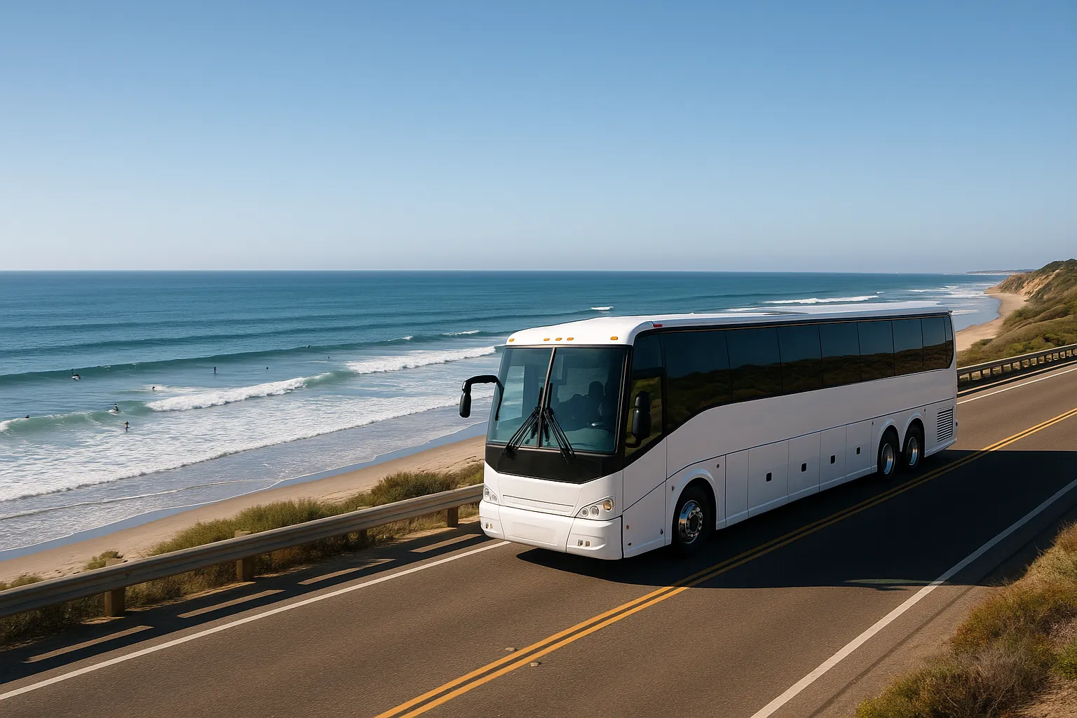 White charter motorcoach parked on a coastal road above the beach in Carlsbad
